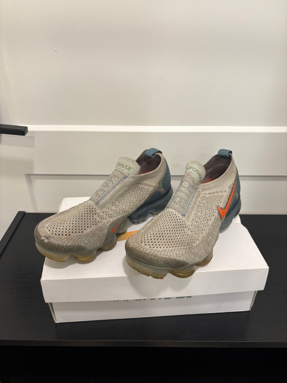 Nike Women’s Slip-On Flyknit Sneakers in Light Beige with Orange Swoosh
